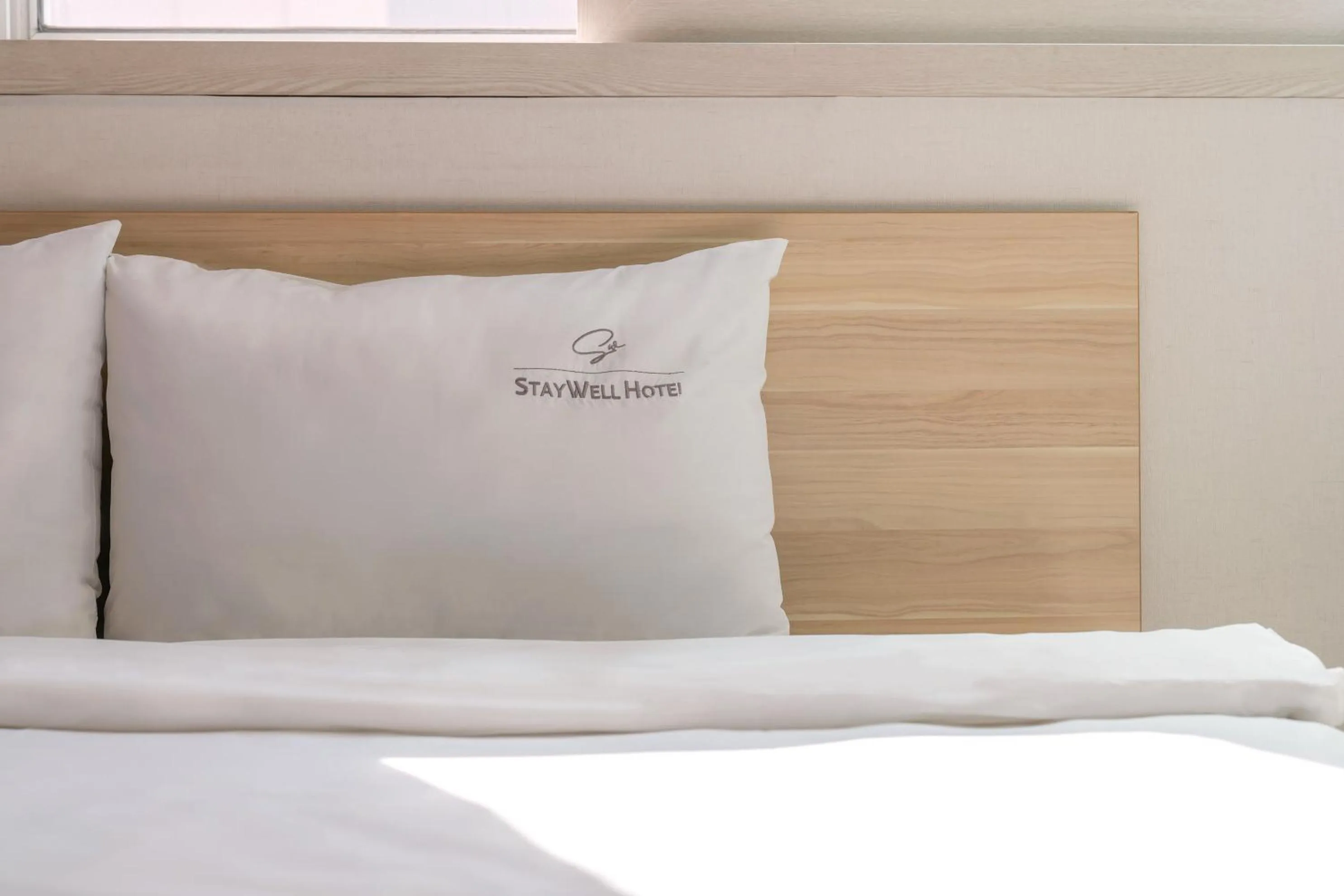 Bed in Staywell Hotel