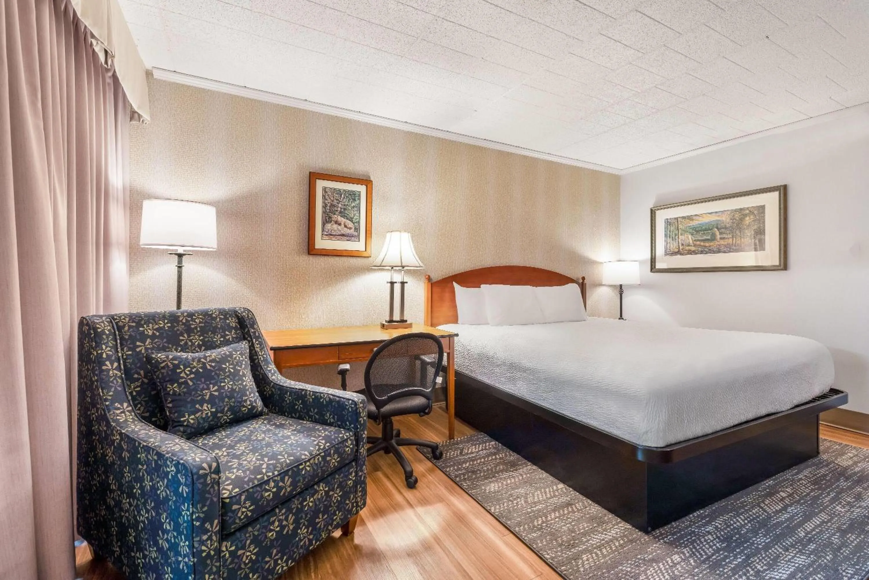 Bed in Ramada by Wyndham State College Hotel & Conference Center