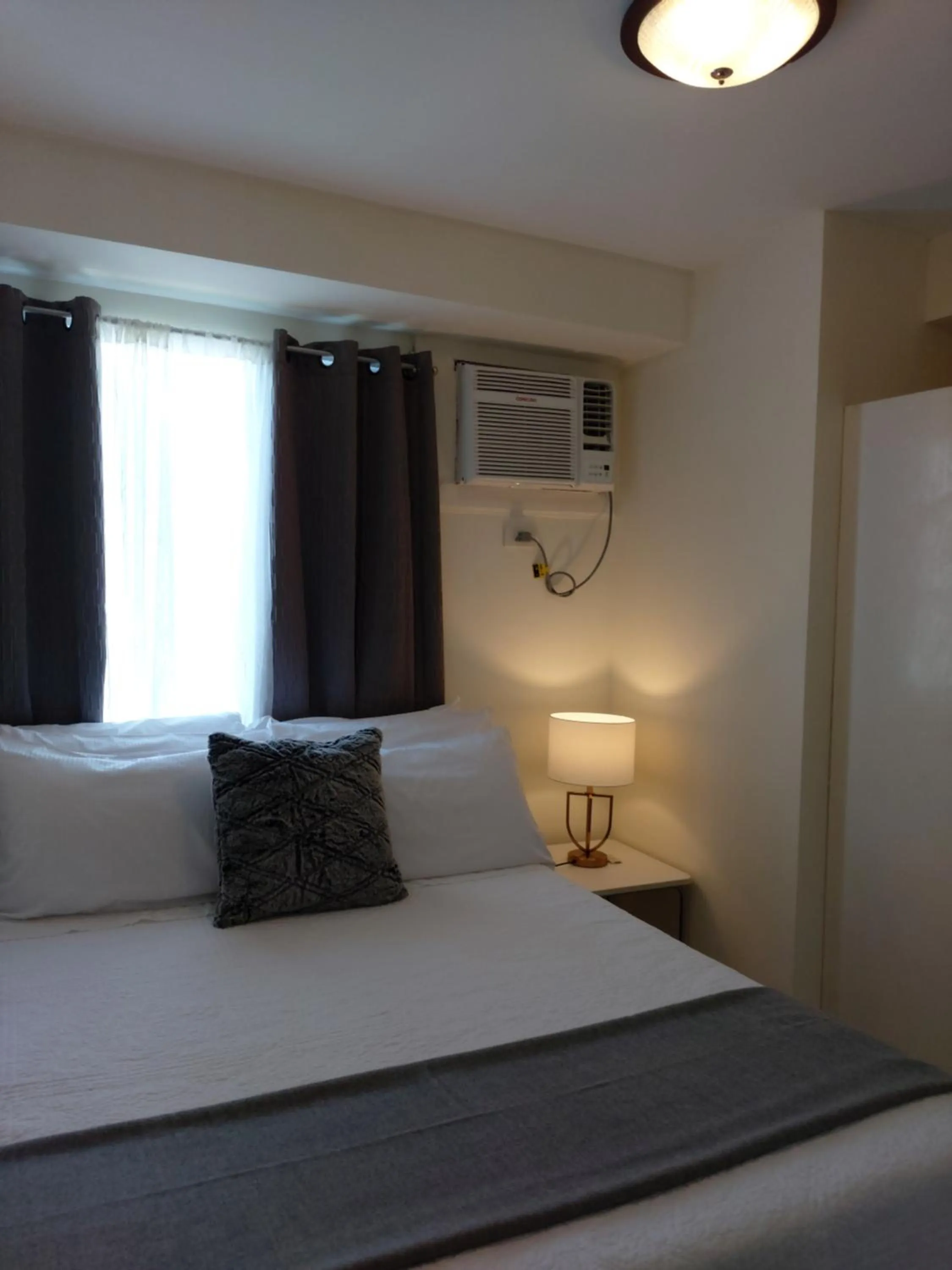 Bed in Condo Studio Luxe in Princeton Residences