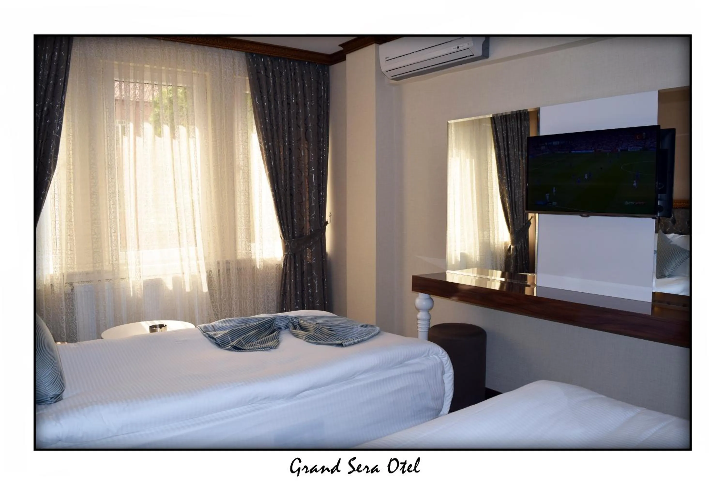 Text overlay, Bed in Grand Sera Hotel