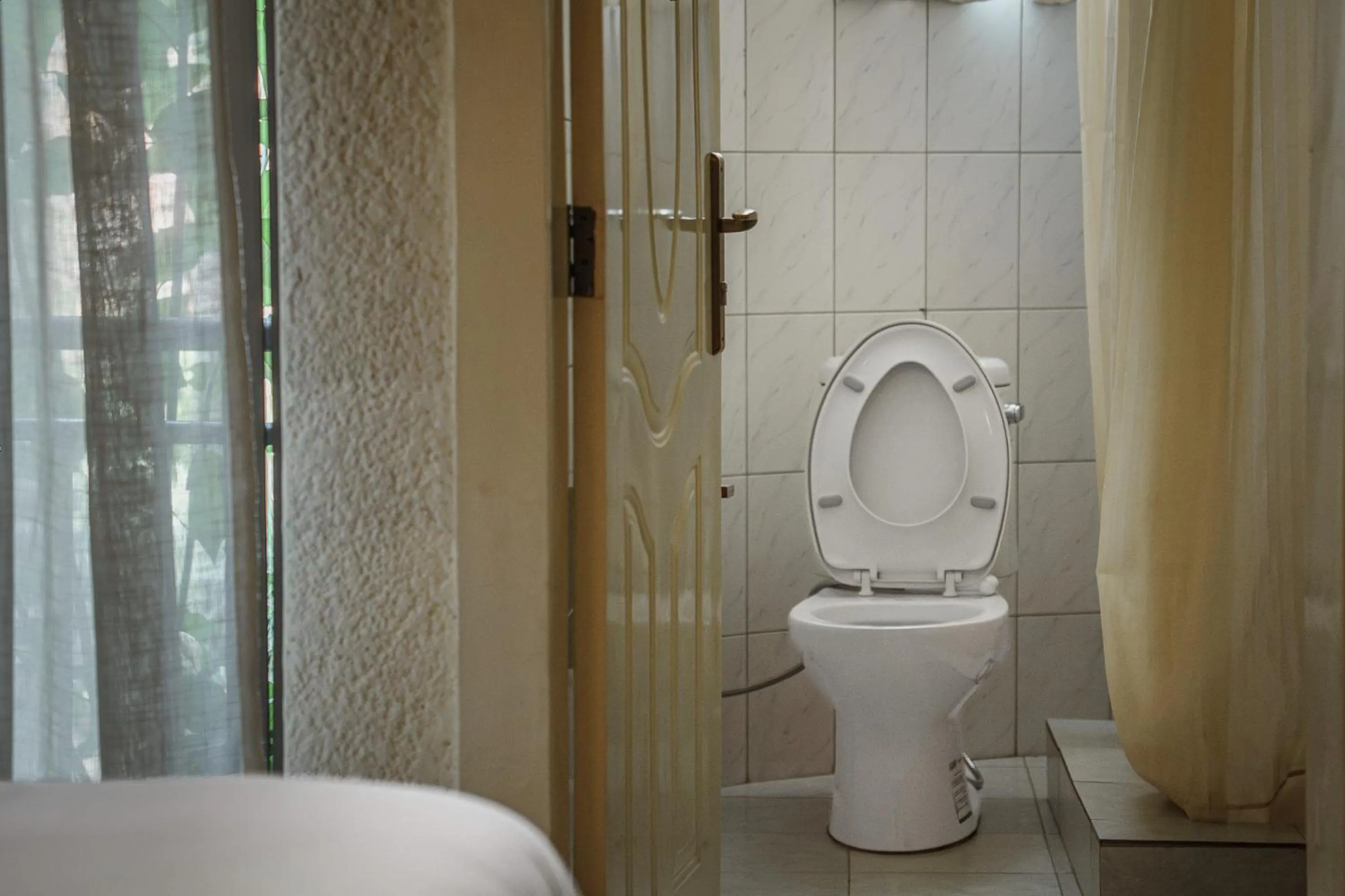 Toilet in Quality Inn Hotel Kigali