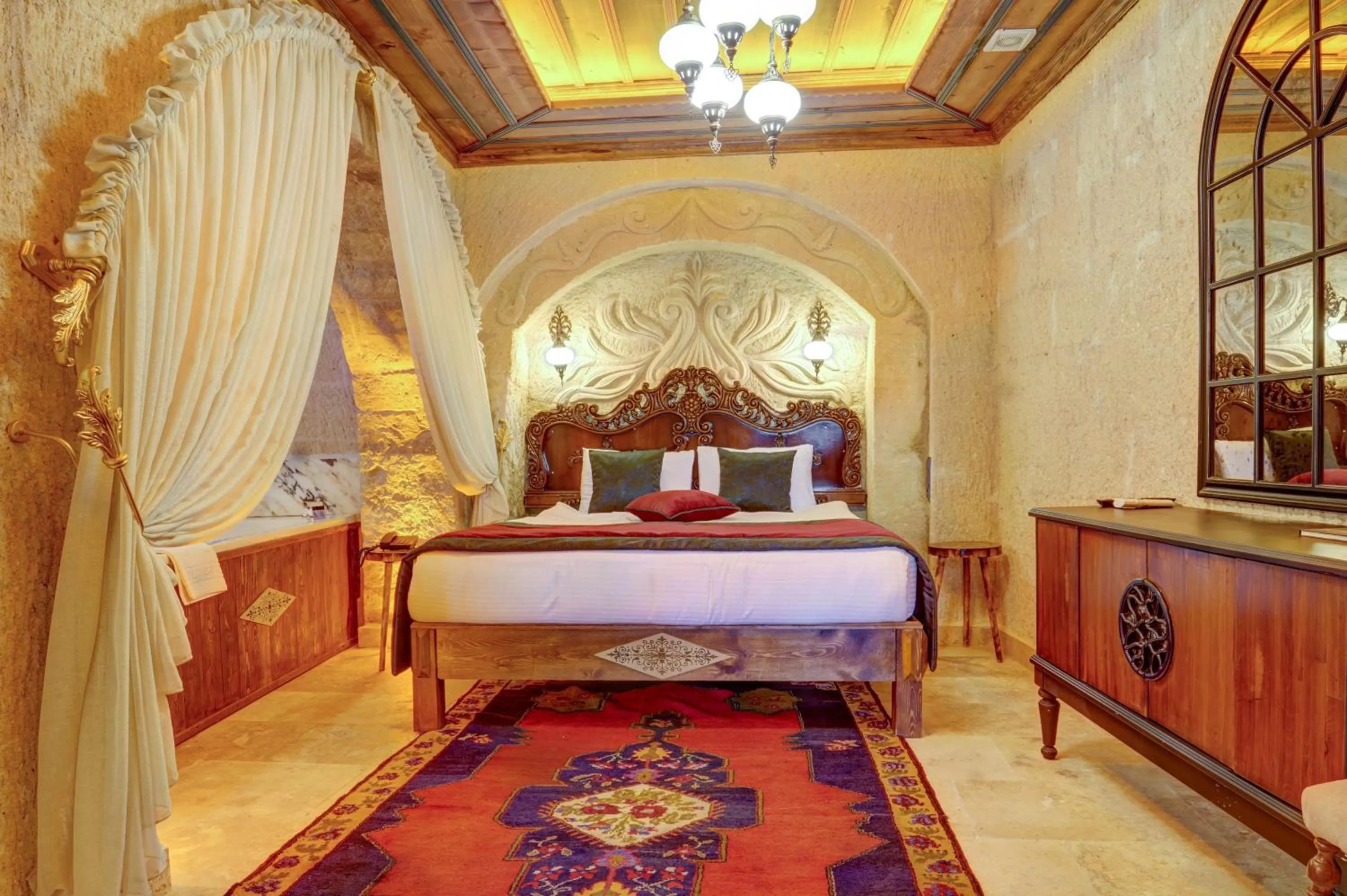 Bed in Kasr-ı Kapadokya Cave Suites