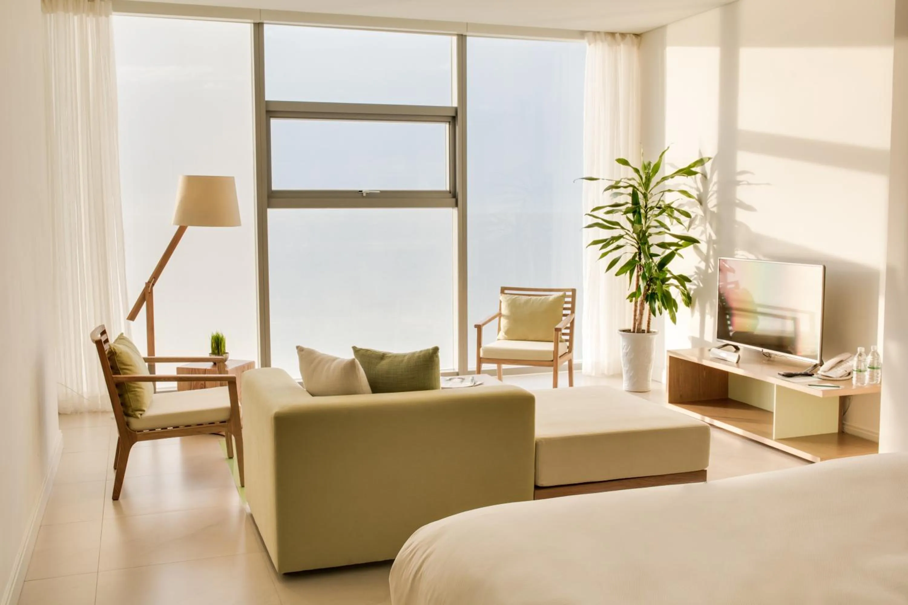 Living room, Bed in Fusion Suites Da Nang