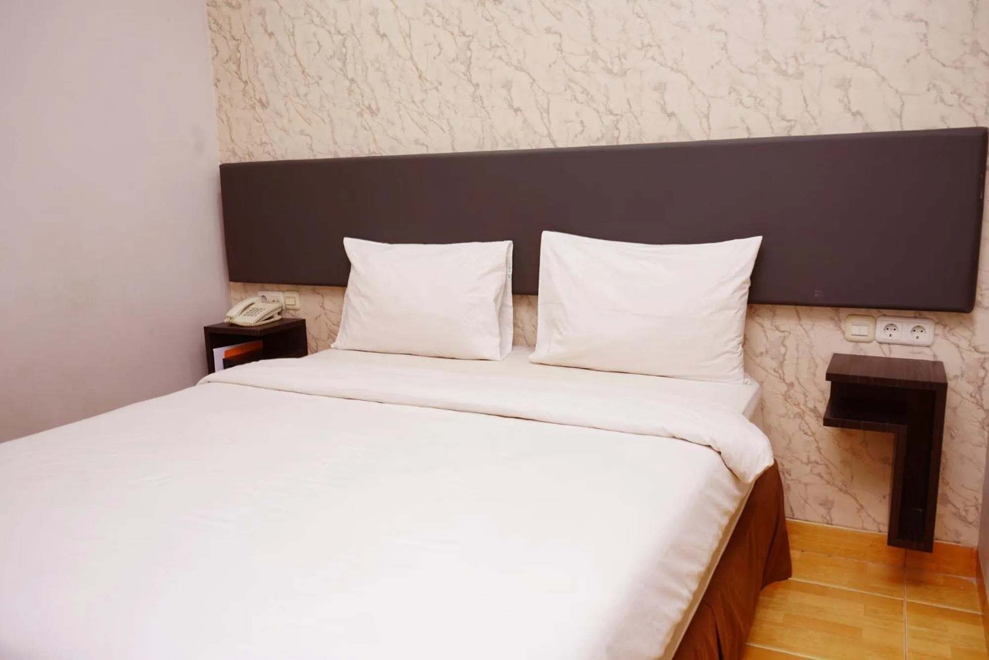 Bed in Grande Hotel Lampung Powered by Archipelago