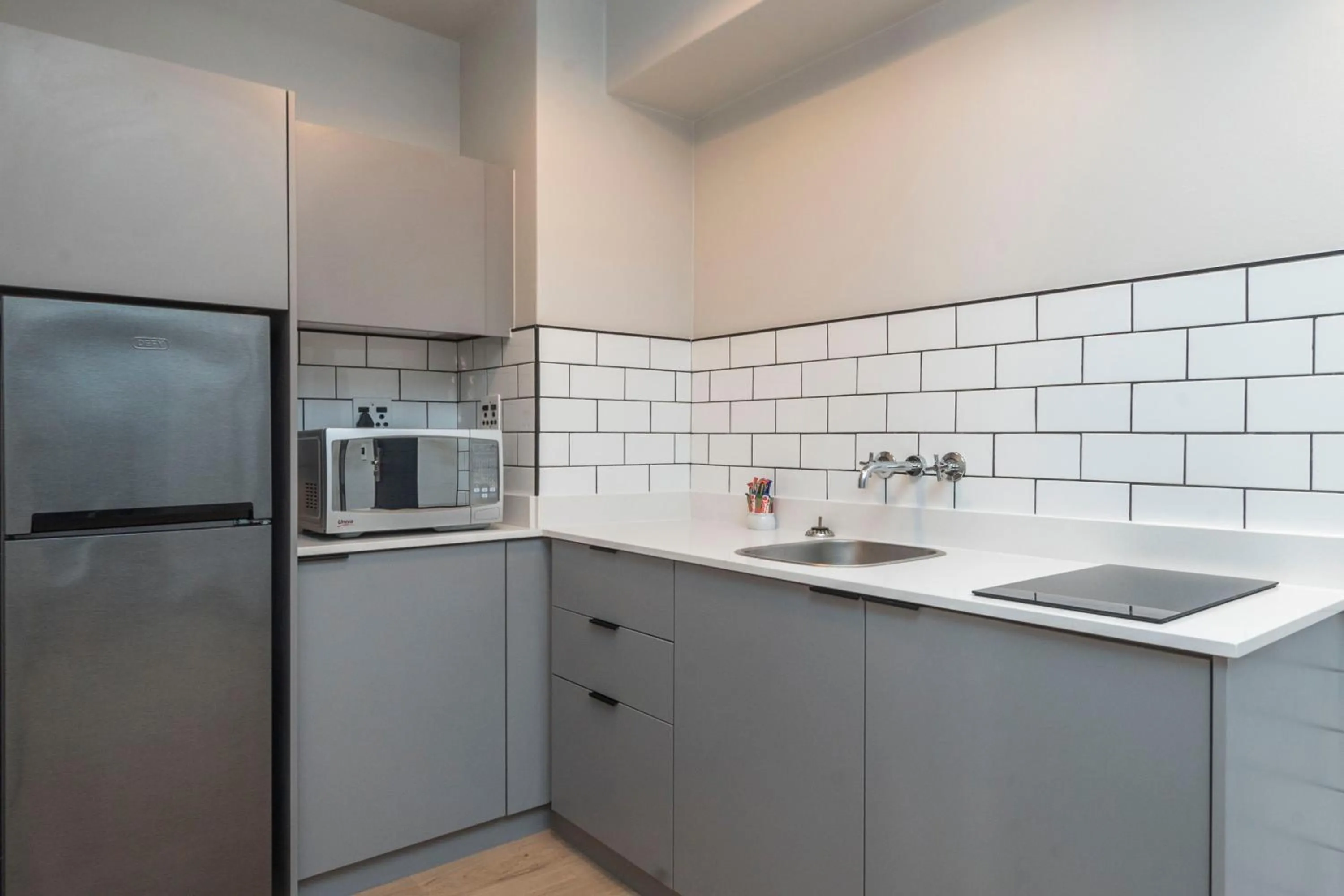 Kitchen or kitchenette in HAVN Aparthotel by Totalstay