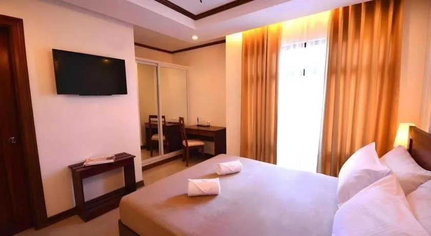 Bed in Ipil Suites Puerto Princesa