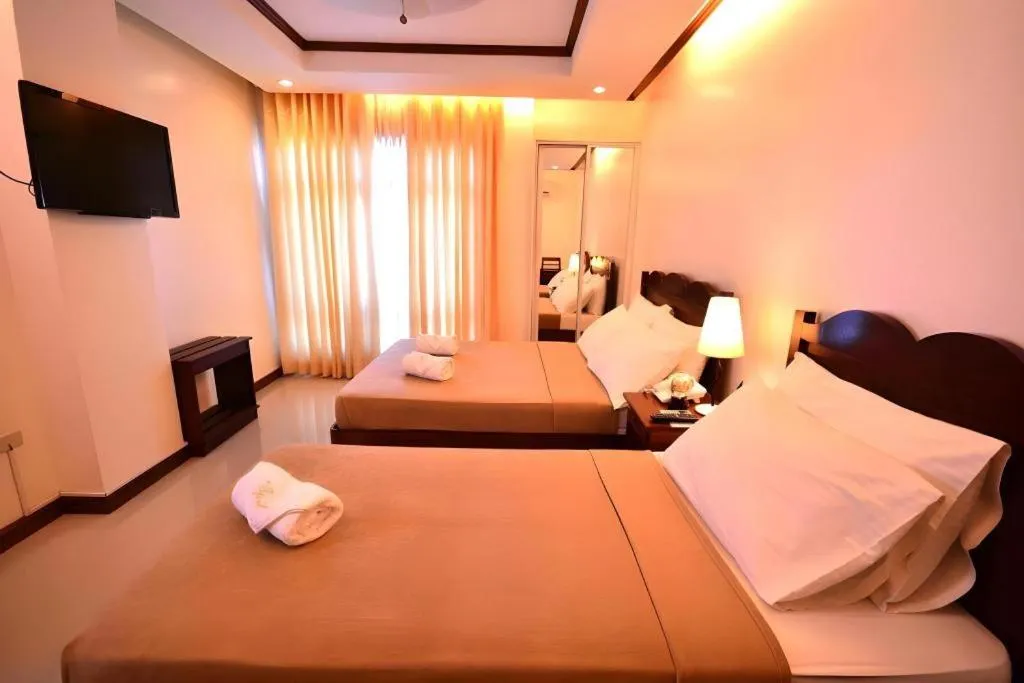 Bed in Ipil Suites Puerto Princesa