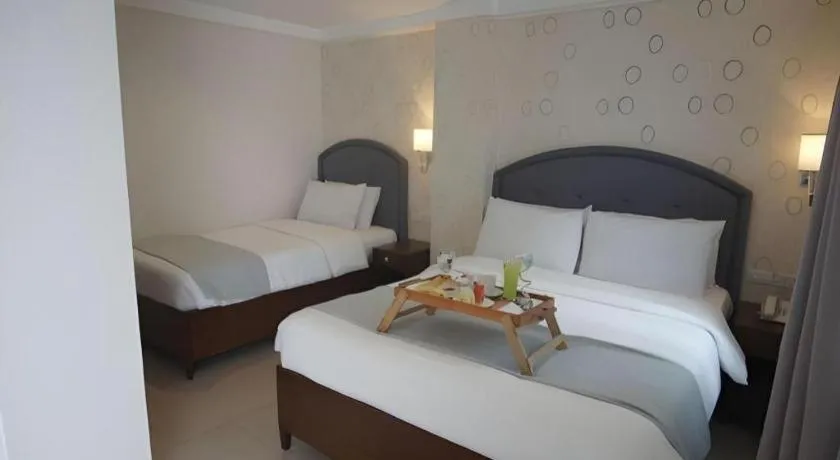 Bed in Queen Margarette Hotel