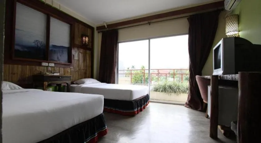 Bed in Phumanee Home Hotel