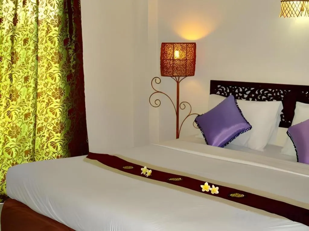 Bed in Phumanee Home Hotel