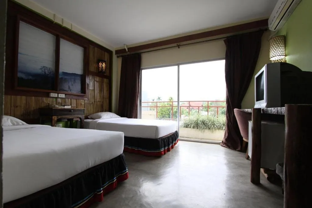 Bed in Phumanee Home Hotel