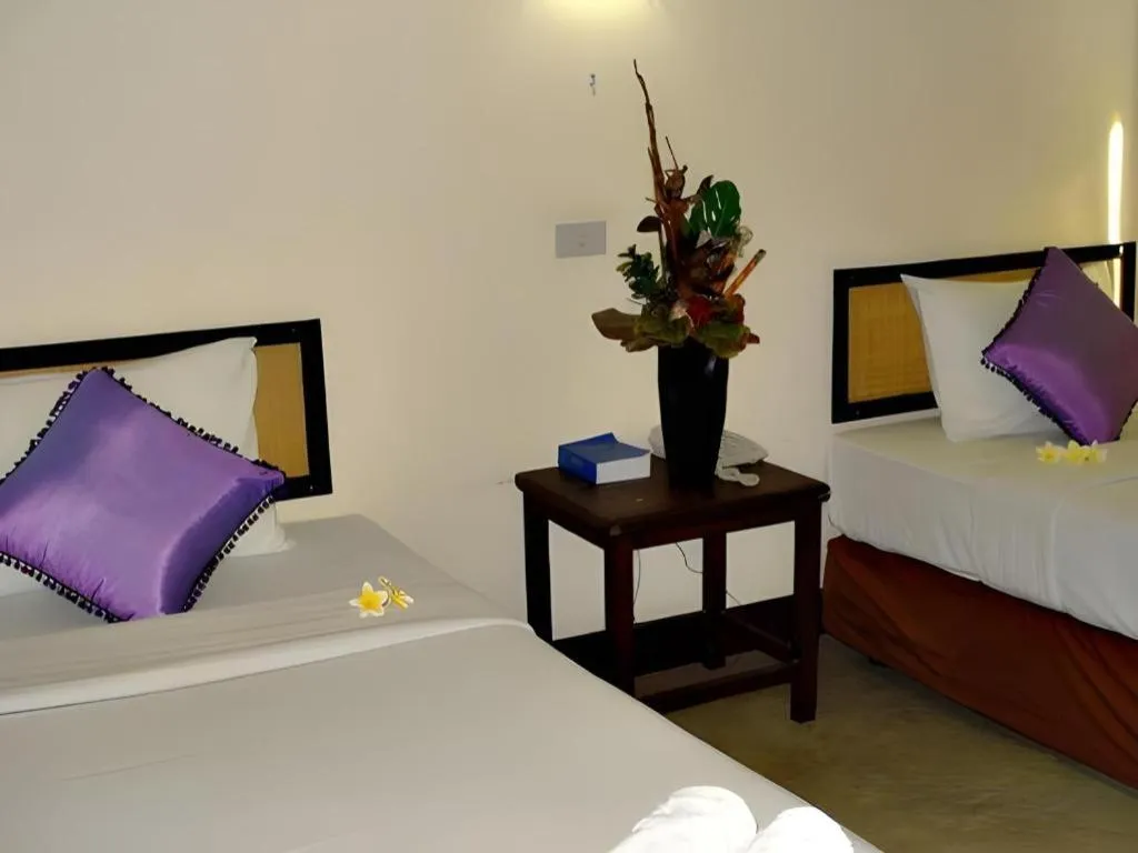 Bed in Phumanee Home Hotel