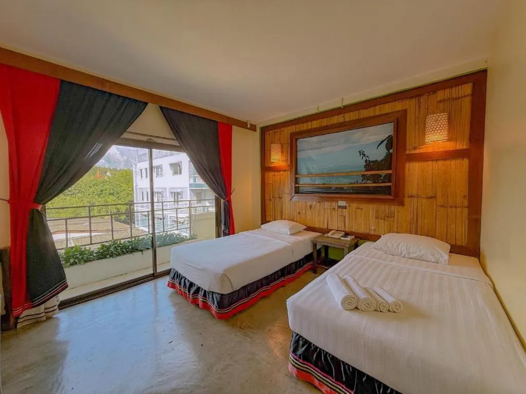 Bed in Phumanee Home Hotel