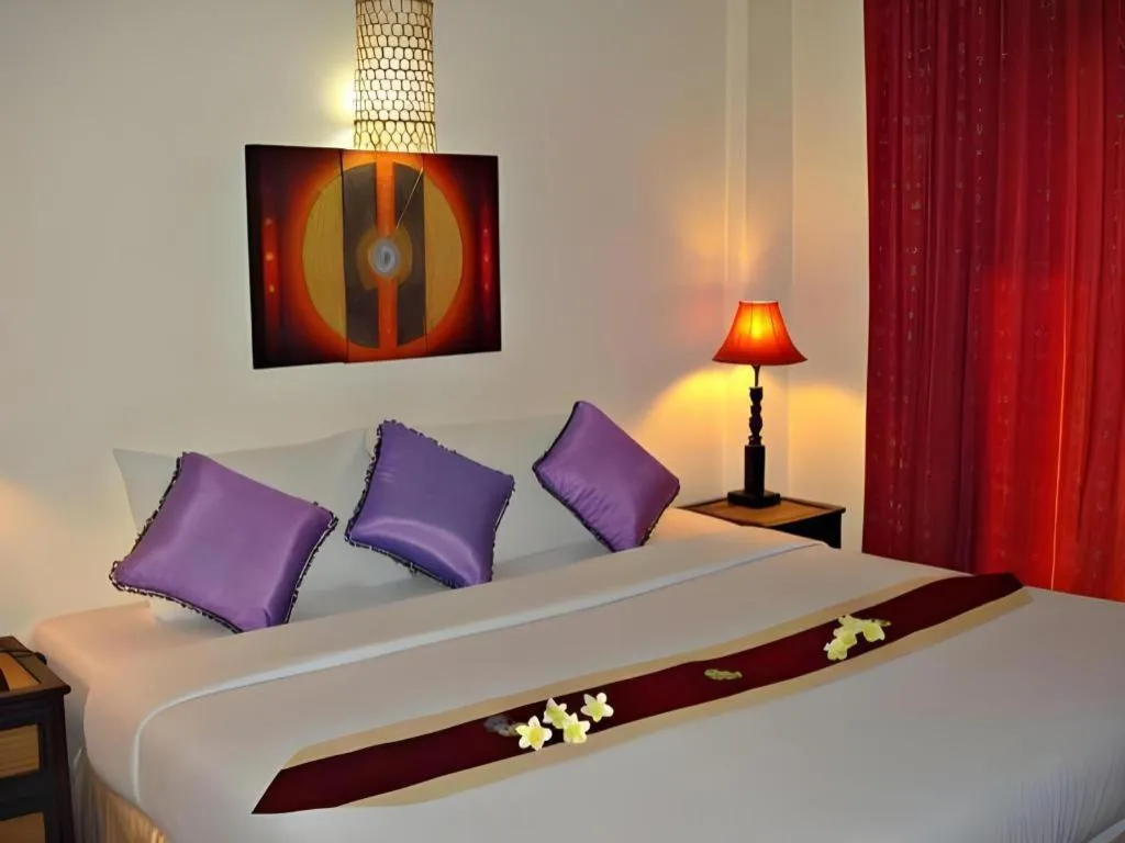 Bed in Phumanee Home Hotel