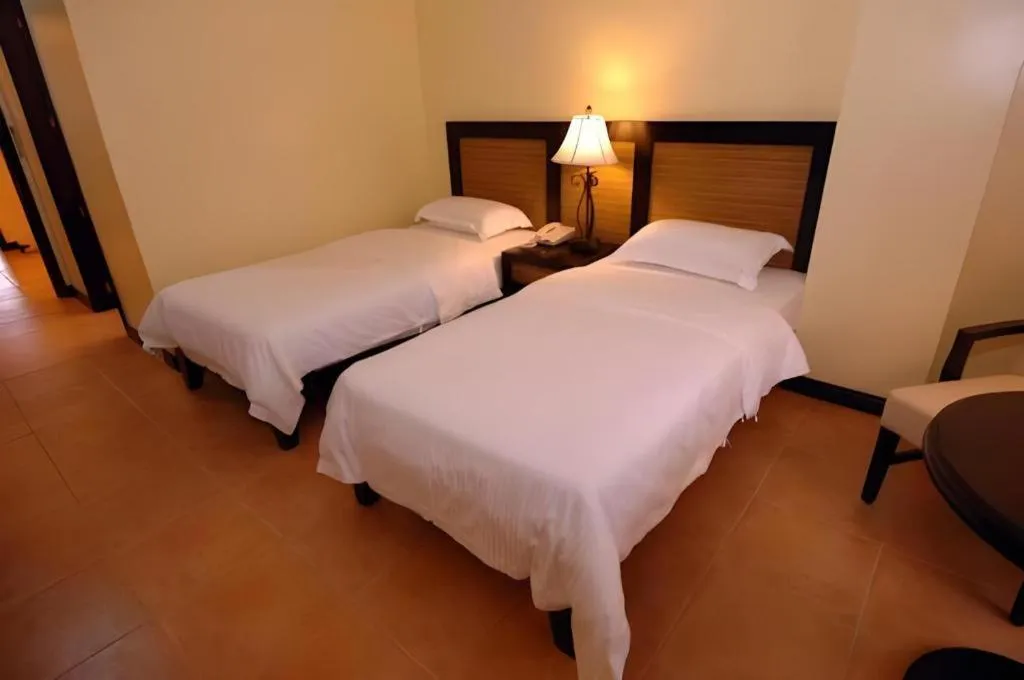 Bed in Planta Centro Bacolod Hotel & Residences