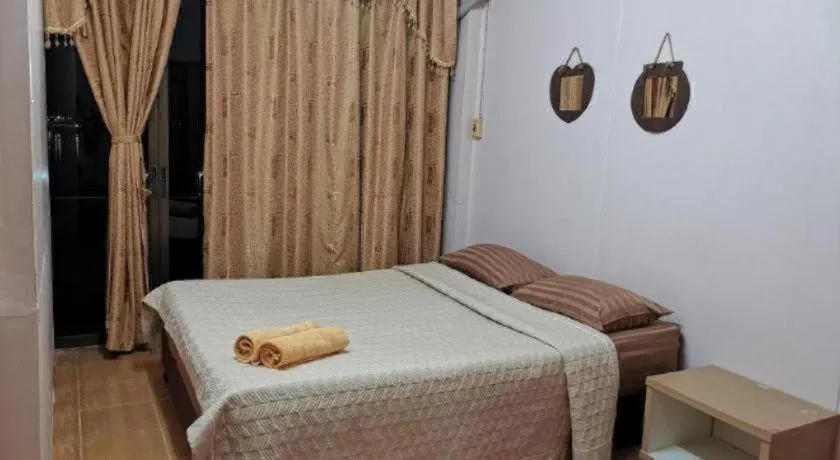 Bed in Just Mansion Hotel