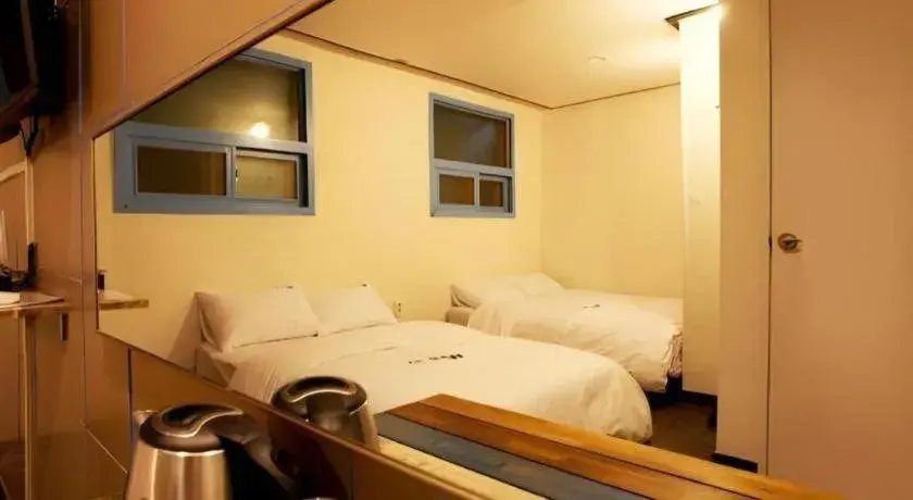 Bed in W Mini Hotel Bed in W Mini Hotel