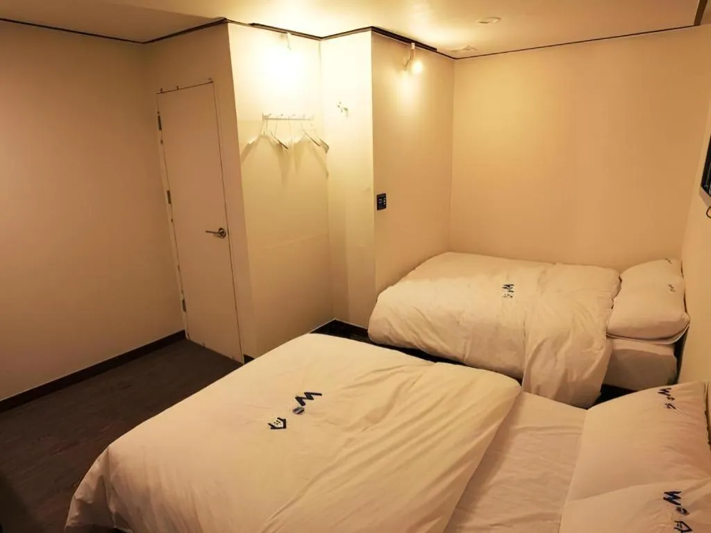 Bed in W Mini Hotel