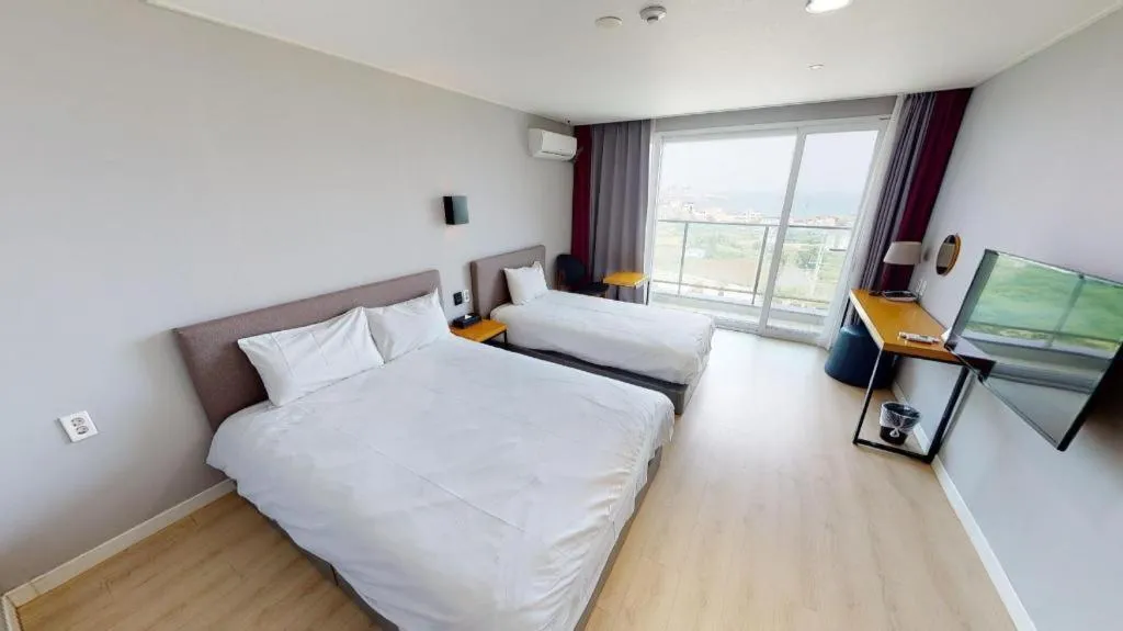 Bed in Sallys Jeju Hotel