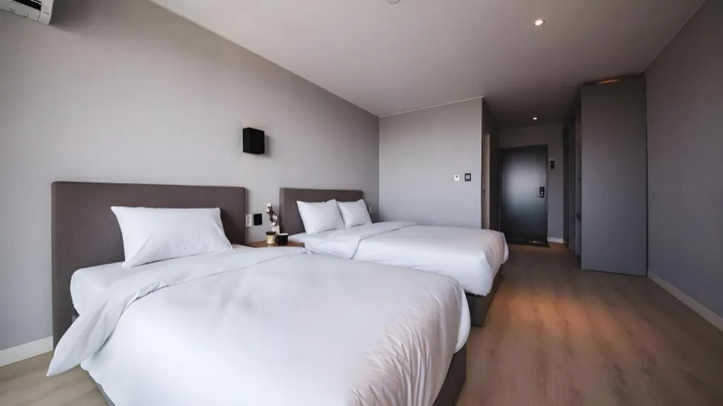 Bed in Sallys Jeju Hotel