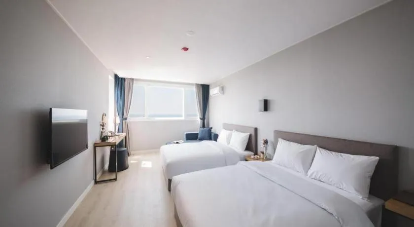 Bed in Sallys Jeju Hotel