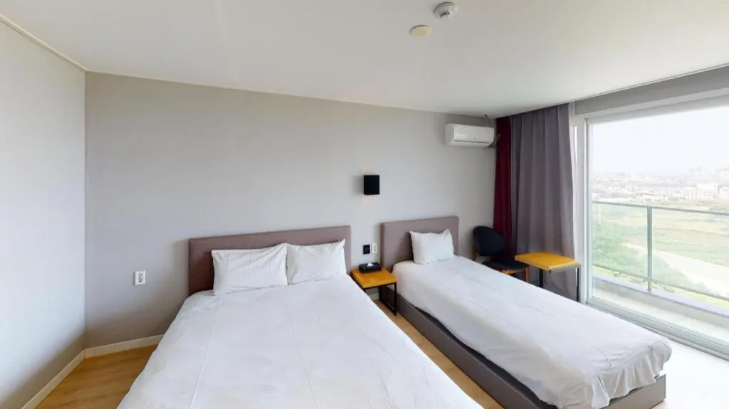 Bed in Sallys Jeju Hotel