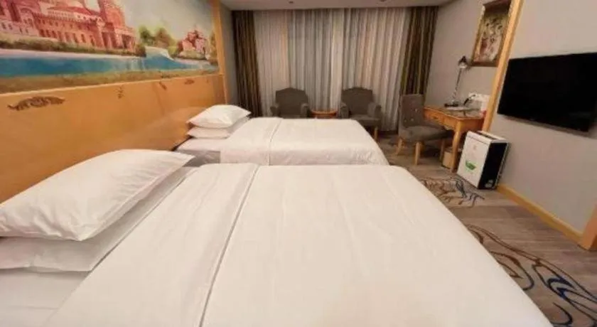 Bed in Vienna Hotel Shenzhen Longgang Dayun Center Branch