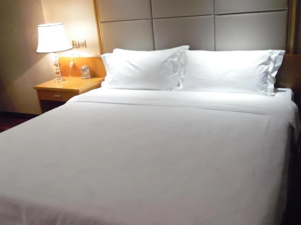 Bed in San Jiang Grand Hotel