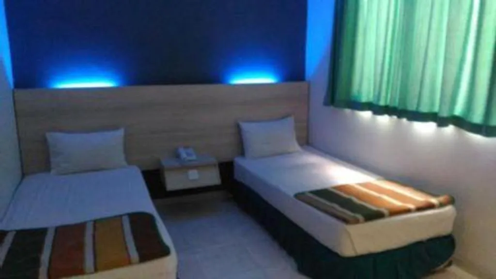 Bed in Kharisma Hotel