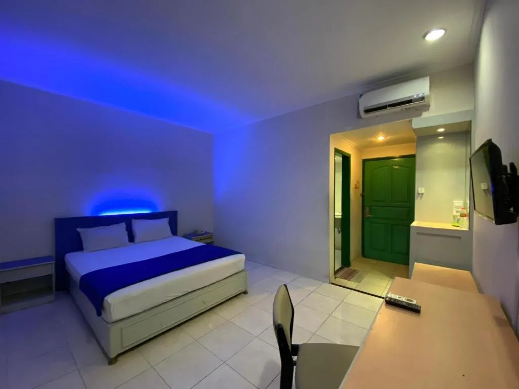 Bed in Kharisma Hotel