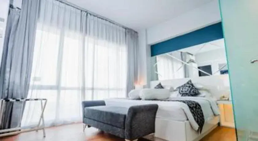 Bed in Grand Darmo Suite by AMITHYA Bed in Grand Darmo Suite by AMITHYA