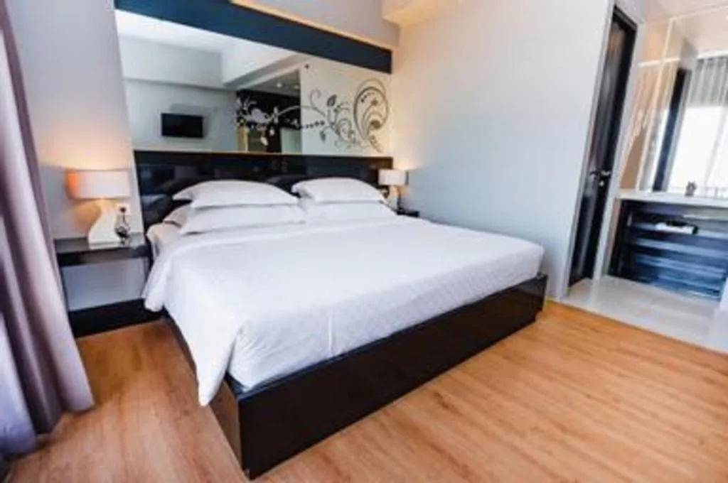 Bed in Grand Darmo Suite by AMITHYA