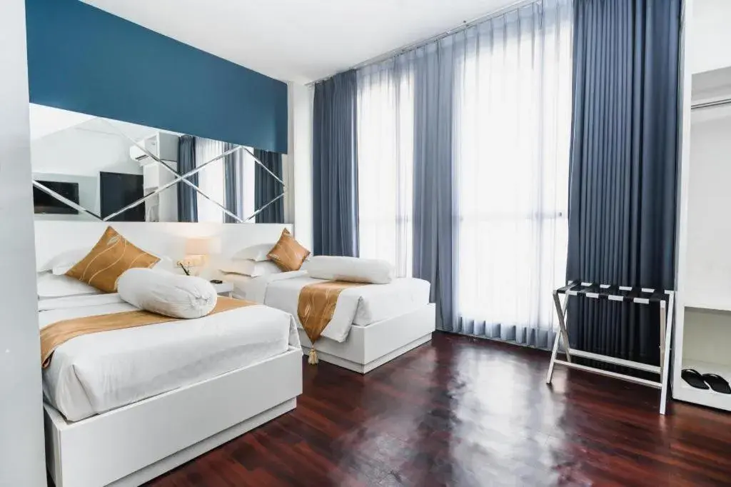 Bed in Grand Darmo Suite by AMITHYA Bed in Grand Darmo Suite by AMITHYA