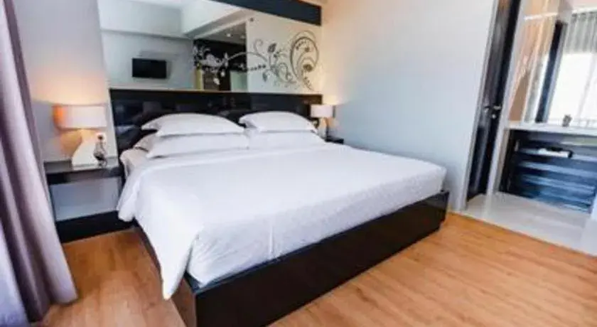 Bed in Grand Darmo Suite by AMITHYA Bed in Grand Darmo Suite by AMITHYA