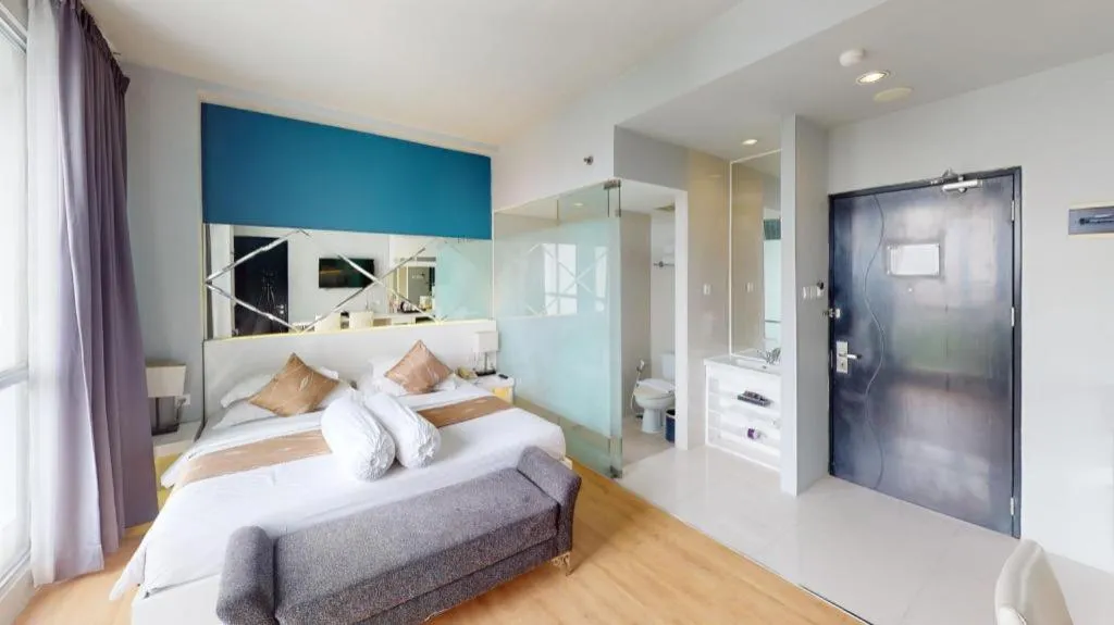 Bed in Grand Darmo Suite by AMITHYA