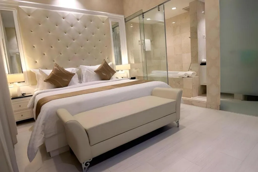 Bed in Grand Darmo Suite by AMITHYA