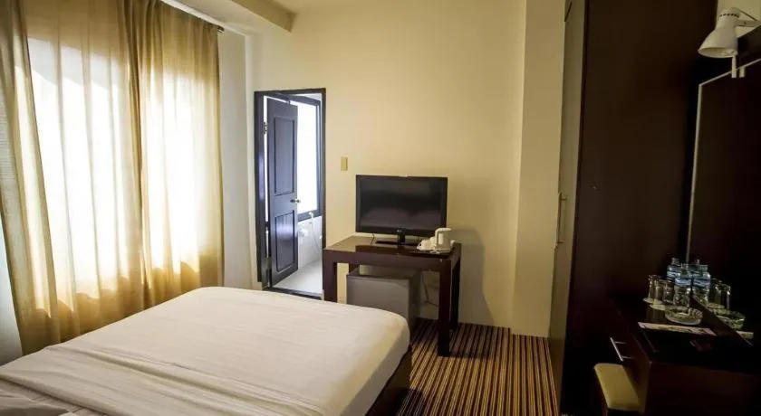 Bed in Kenari Tower Hotel