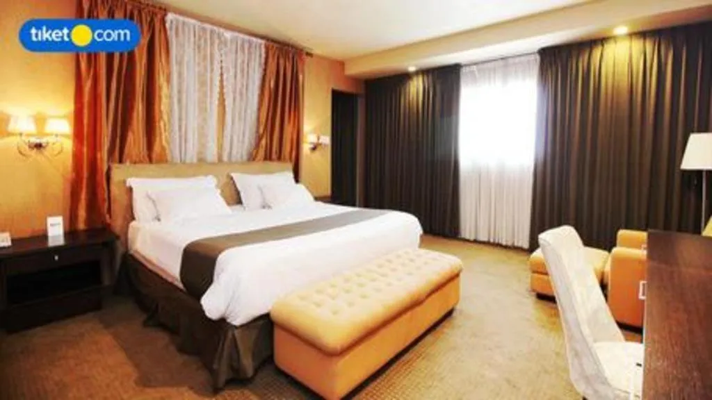 Bed in Kenari Tower Hotel