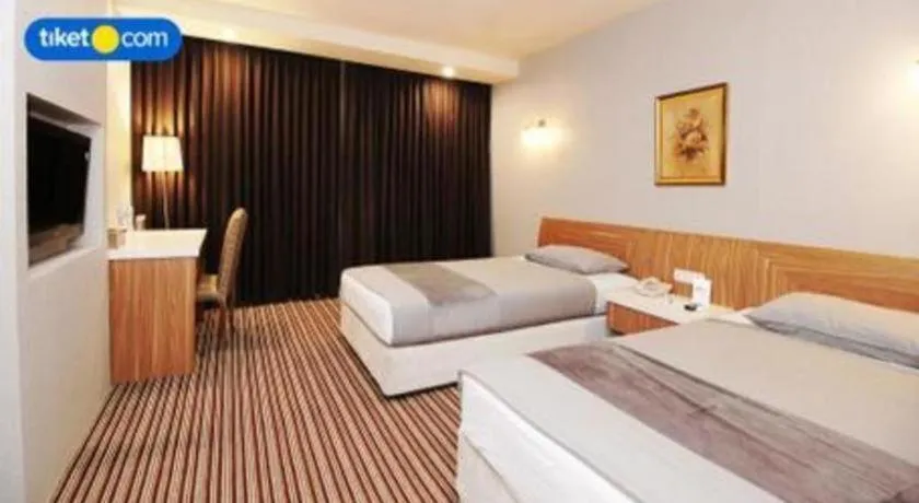 Bed in Kenari Tower Hotel