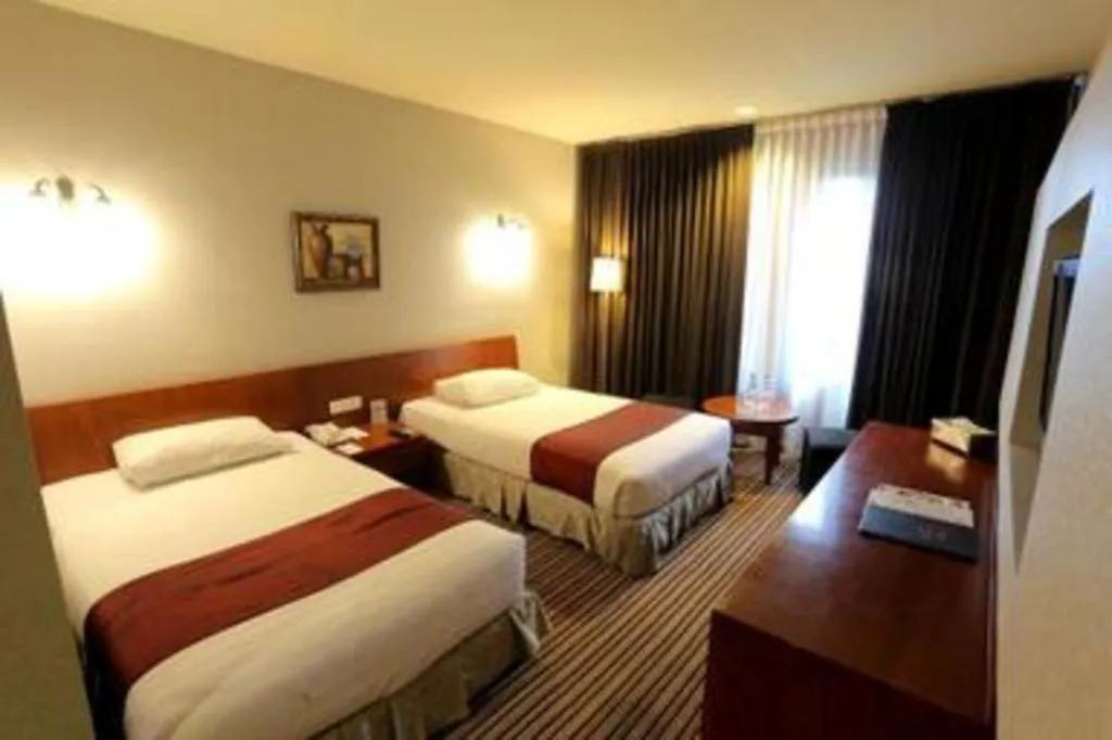 Bed in Kenari Tower Hotel