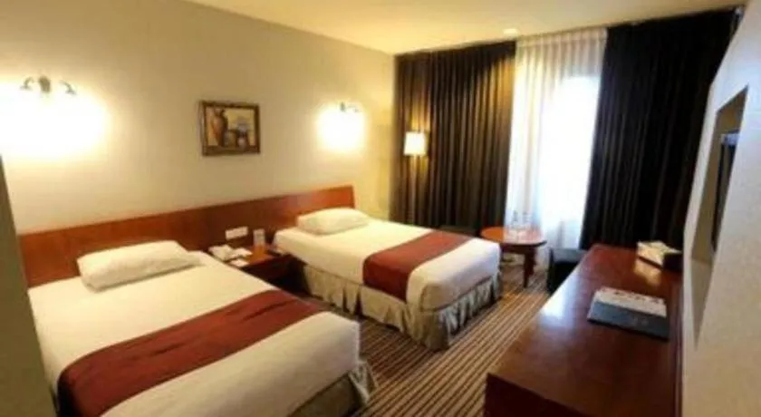 Bed in Kenari Tower Hotel