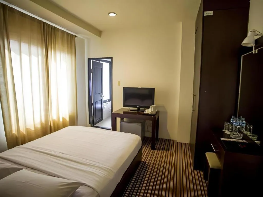 Bed in Kenari Tower Hotel