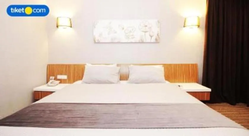 Bed in Kenari Tower Hotel