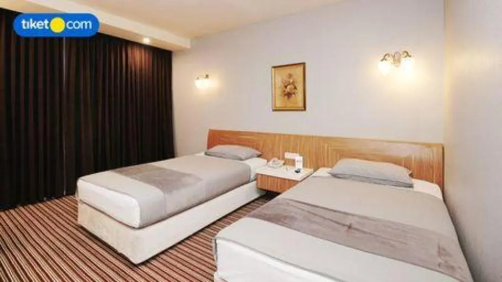 Bed in Kenari Tower Hotel