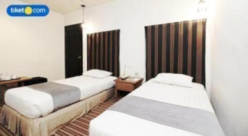 Bed in Kenari Tower Hotel