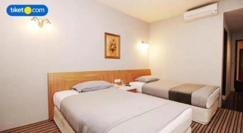 Bed in Kenari Tower Hotel