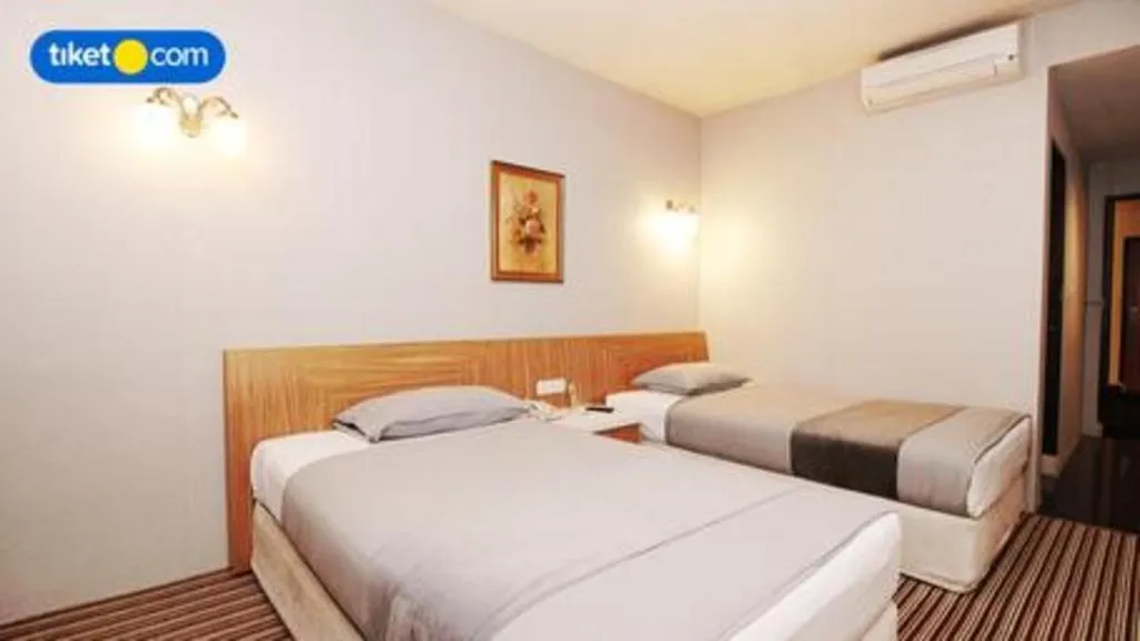 Bed in Kenari Tower Hotel