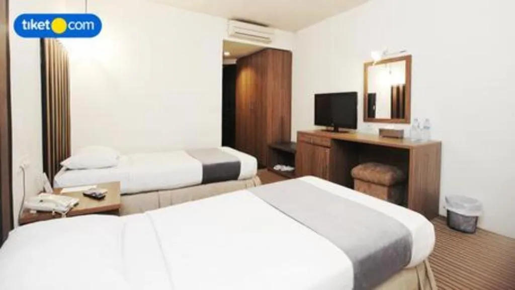 Bed in Kenari Tower Hotel