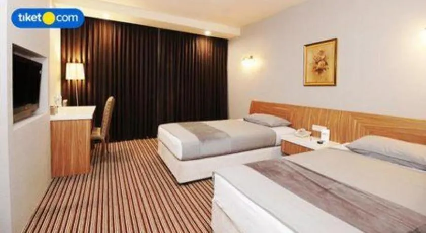 Bed in Kenari Tower Hotel