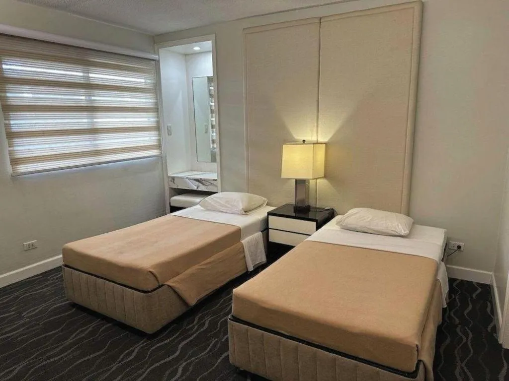 Bed in Amorsolo Mansion Hotel